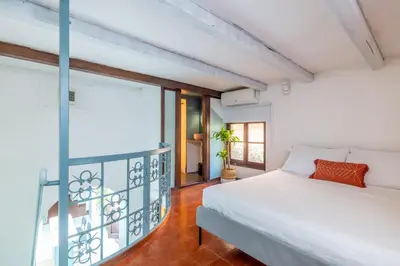 a bedroom with a bed and a large window at Domus Fori Imperiali in Rome