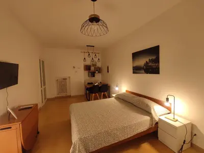 a bedroom with a bed and a tv and a table at Ponentino B&B in Rome