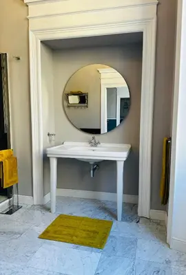 a bathroom with a sink and a mirror at Via Veneto Luxury House in Rome