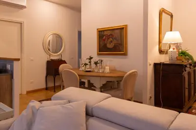 a living room with a table and a couch at Appartamento Coppedè in Rome