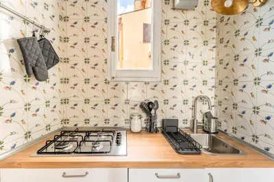 a kitchen with a sink and a stove top oven at Gn Suite Oro in Rome