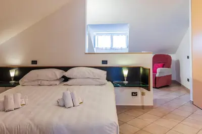 a bedroom with a large bed with two pillows at FCR Rome Apartments Ponte Milvio - Fleming in Rome