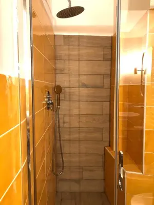 a bathroom with a shower with a glass door at Eurialo Roma Design Apartment - MyItalianStay in Rome