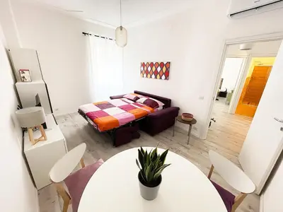 a bedroom with a bed and a table and chairs at Eurialo Roma Design Apartment - MyItalianStay in Rome