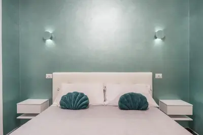 a bedroom with a bed with two pillows on it at San Giovanni apartment in Rome