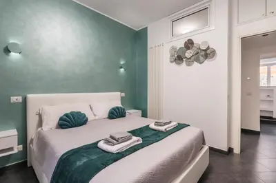 a bedroom with a large bed with towels on it at San Giovanni apartment in Rome
