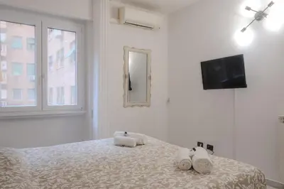 a white bedroom with a bed with towels on it at Casa Daniela in Rome