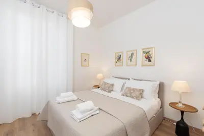 a white bedroom with a bed with towels on it at 25 Penthouse Porta Pia in Rome