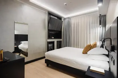 a bedroom with a bed and a desk in a room at Dream Suite Trevi in Rome