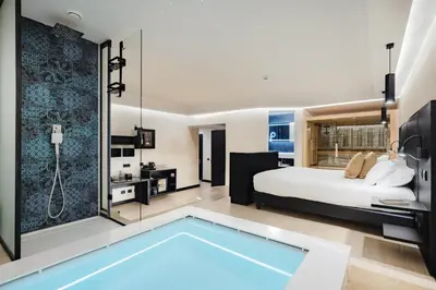 a bedroom with a bed and a swimming pool at Dream Suite Trevi in Rome