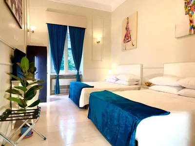 a hotel room with two beds with blue curtains at Madame Sofia Exclusive Collection Spanish Steps - HOME Apartment-Suites in Rome