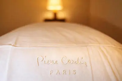 a white bed with a sign that says pocus east paris at Madame Sofia Exclusive Collection Spanish Steps - HOME Apartment-Suites in Rome