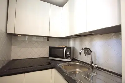 a kitchen with a sink and a microwave at Testaccio View Holiday House in Rome