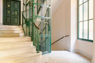 a staircase with a green door in a house at Roma private rooms Vatican City in Rome