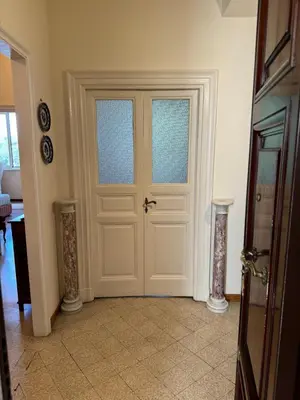 a white door with two windows in a room at Casa Salimei in Rome