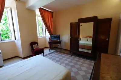 a hotel room with a bed and a mirror at Casa Salimei in Rome