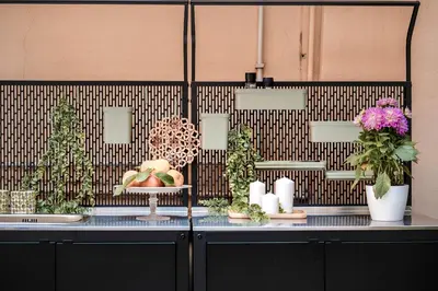 a counter with flowers and candles and trees on it at Appartamento San Giovanni fino a 6 persone in Rome