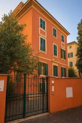 an orange building with a fence in front of it at Like at Home Trastevere in Rome