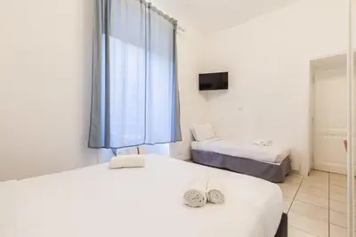 a bedroom with two beds and a window at Hostly-Michelangelo Cloister Suite-Center of Rome in Rome
