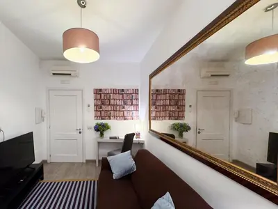 a living room with a large mirror and a couch at Banchi Vecchi Stay Apt Suite Pantheon in Rome