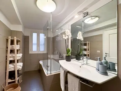 a bathroom with a sink and a tub and a mirror at Banchi Vecchi Stay Apt Suite Pantheon in Rome