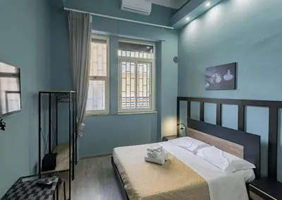 a bedroom with a bed in a room with blue walls at Aquas Salvias in Rome