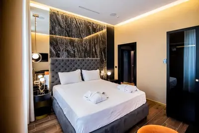 a bedroom with a large bed with two towels on it at Luxury Rhome Via della Croce in Rome
