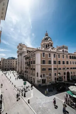 a large building with people walking in front of it at Luxury Rhome Via della Croce in Rome