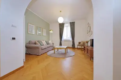 a living room with a couch and a table at YCH-Comfortable 2 bedrooms flat near Colosseum in Rome