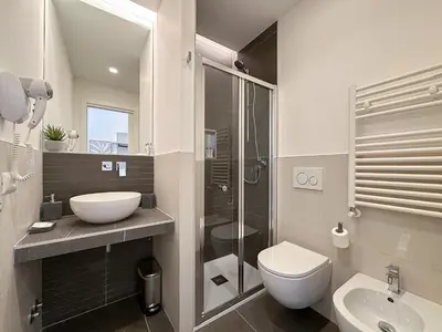 a white hallway with a bed in a bedroom at White Ottaviano in Rome
