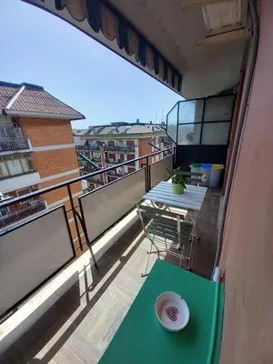 a balcony with a table and a plate on it at La mia casetta a Porta Furba in Rome