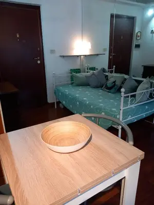 a table with a wooden bowl on top of it at La mia casetta a Porta Furba in Rome
