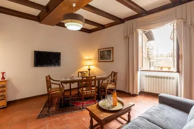 a living room with a table and chairs at Roma Centro Storico Luxury - Piazza di Spagna in Rome
