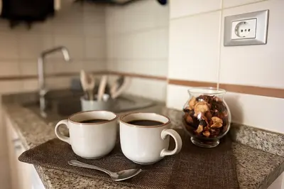 two cups of coffee sitting on a kitchen counter at S&M Guest Home - San Giovanni in Rome