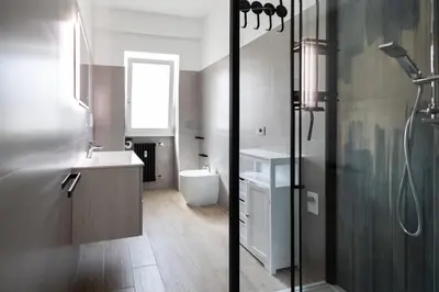 a bathroom with a shower and a sink and a toilet at Marconi white flower house in Rome