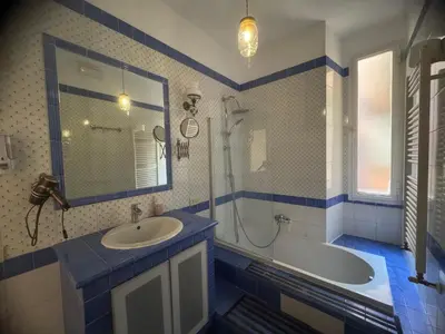 a bathroom with a sink and a tub and a mirror at Domus Filiberto by Local Domus in Rome