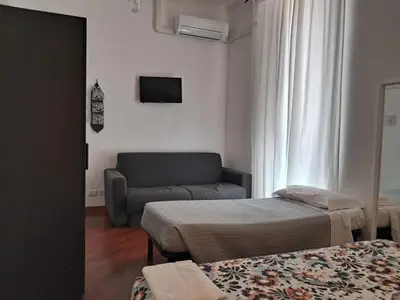 a living room with two beds and a couch at Domus Filiberto by Local Domus in Rome