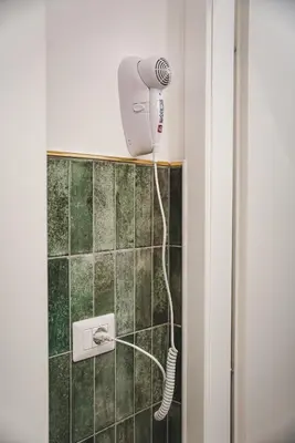 a shower with a blow dryer in a bathroom at Tibur Domus B&B in Rome