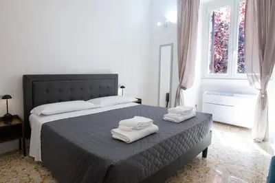 a bedroom with a bed with two towels on it at Vatican 23 Museum Suites in Rome