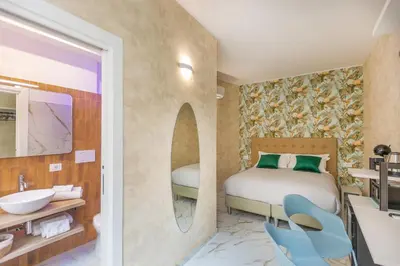 a hotel room with a bed and a bathroom at Flowery Rainbow in Rome