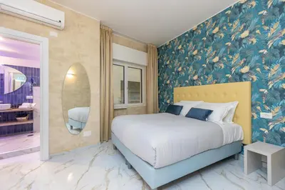 a bedroom with a bed and a wall with flowers at Flowery Rainbow in Rome