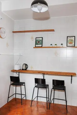 a kitchen with two chairs and a counter with a table at RHOME SUITE VATICAN APTS in Rome