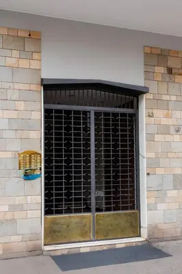 a building with a window with a cage on it at RHOME SUITE VATICAN APTS in Rome