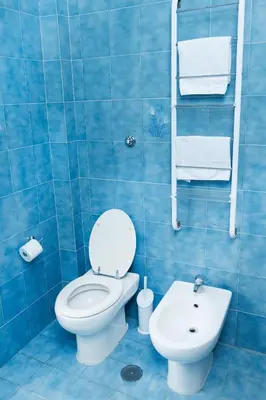 a blue tiled bathroom with a toilet and a sink at RHOME SUITE VATICAN APTS in Rome