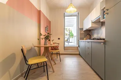 a small kitchen with a table and chairs at YCH-Ambra Apartments a San Giovanni in Rome