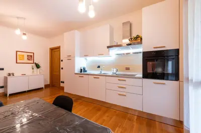 a kitchen with white cabinets and a black microwave at Bonum Vitae in Rome
