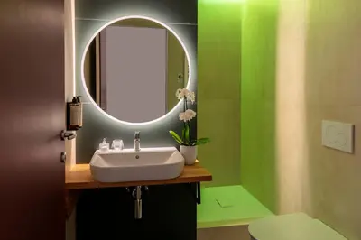 a bathroom with a sink and a mirror at Residenza Il Vicolo by Hili in Rome