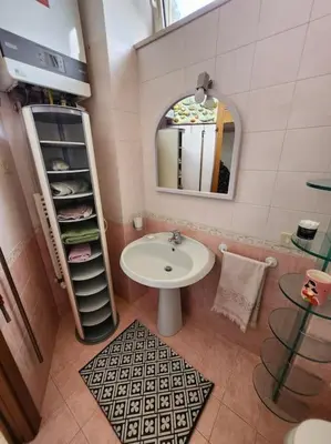 a bathroom with a sink and a mirror at Appartamento Loft ex mulini in Rome