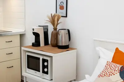 a microwave on top of a white cabinet in a kitchen at Archetto by the Vatican in Rome