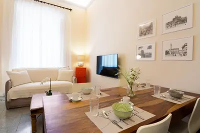 a living room with a table and a couch at Quirino Visconti Apartment Prati in Rome